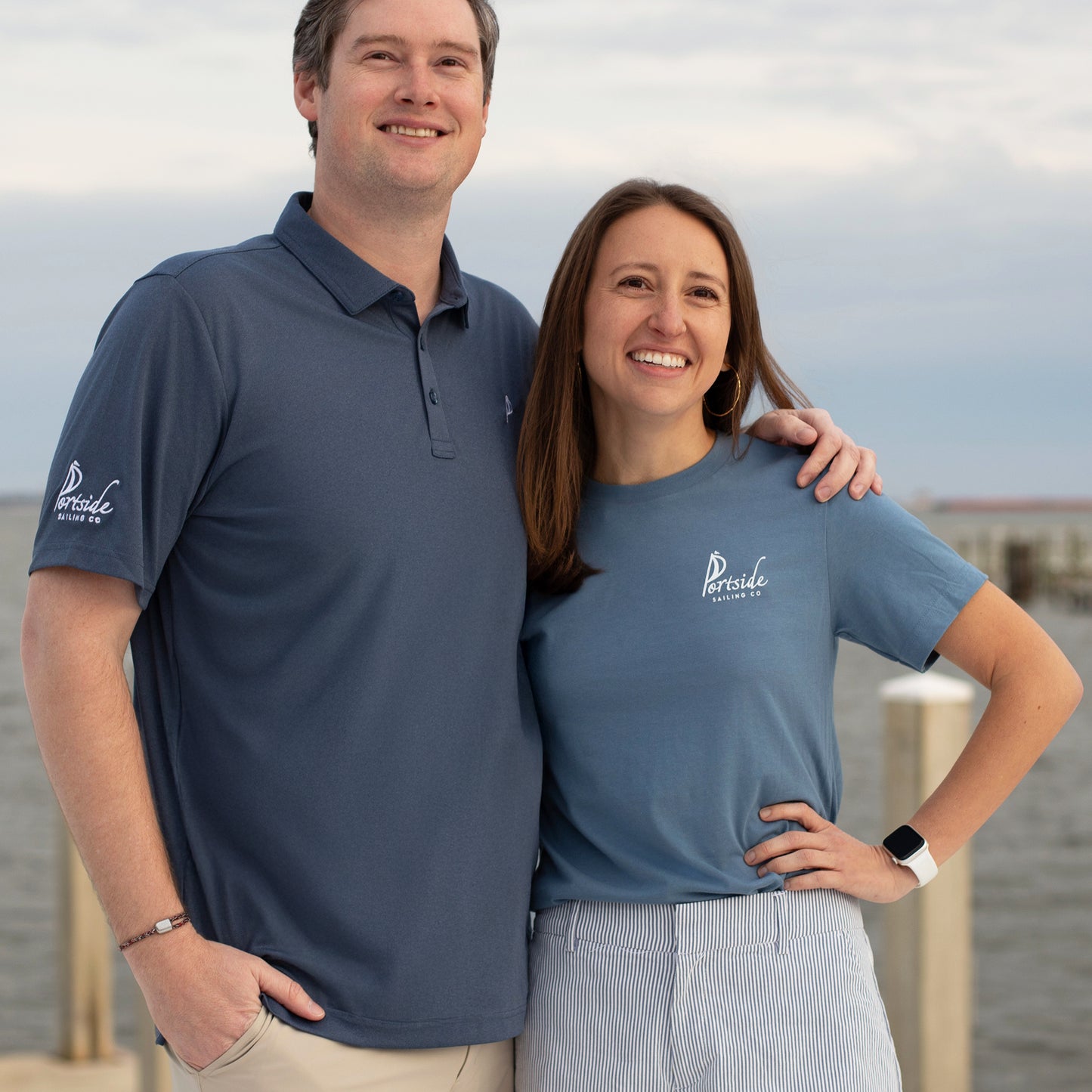 Couple dressed in their Portside Sailing Co. Pensacola gear, showcasing a perfect blend of nautical style and local pride.