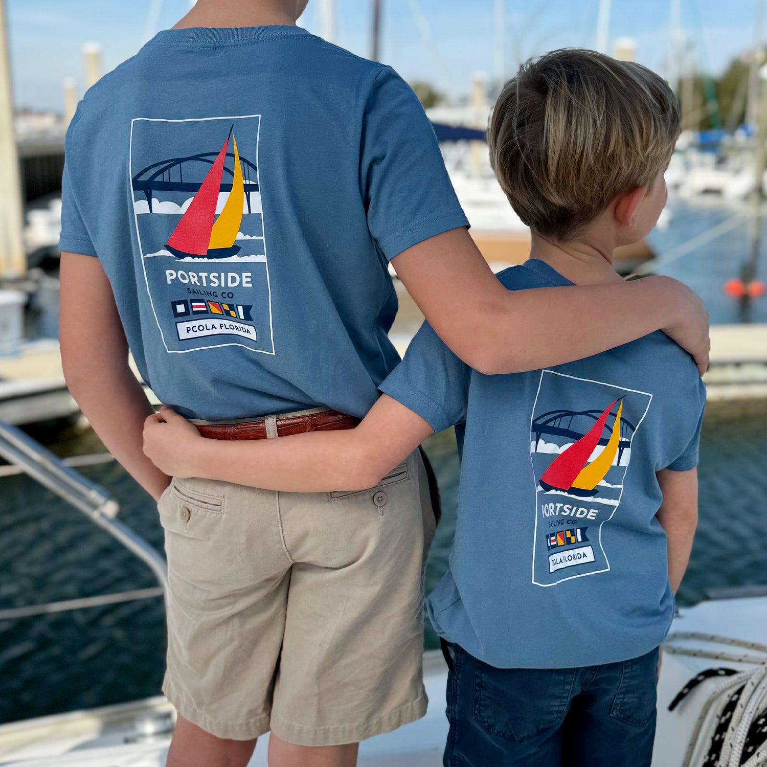 Adult and kid t-shirt featuring an artistic graphic of the iconic Pensacola Bay Bridge, perfect for lovers of Pensacola’s scenic beauty.