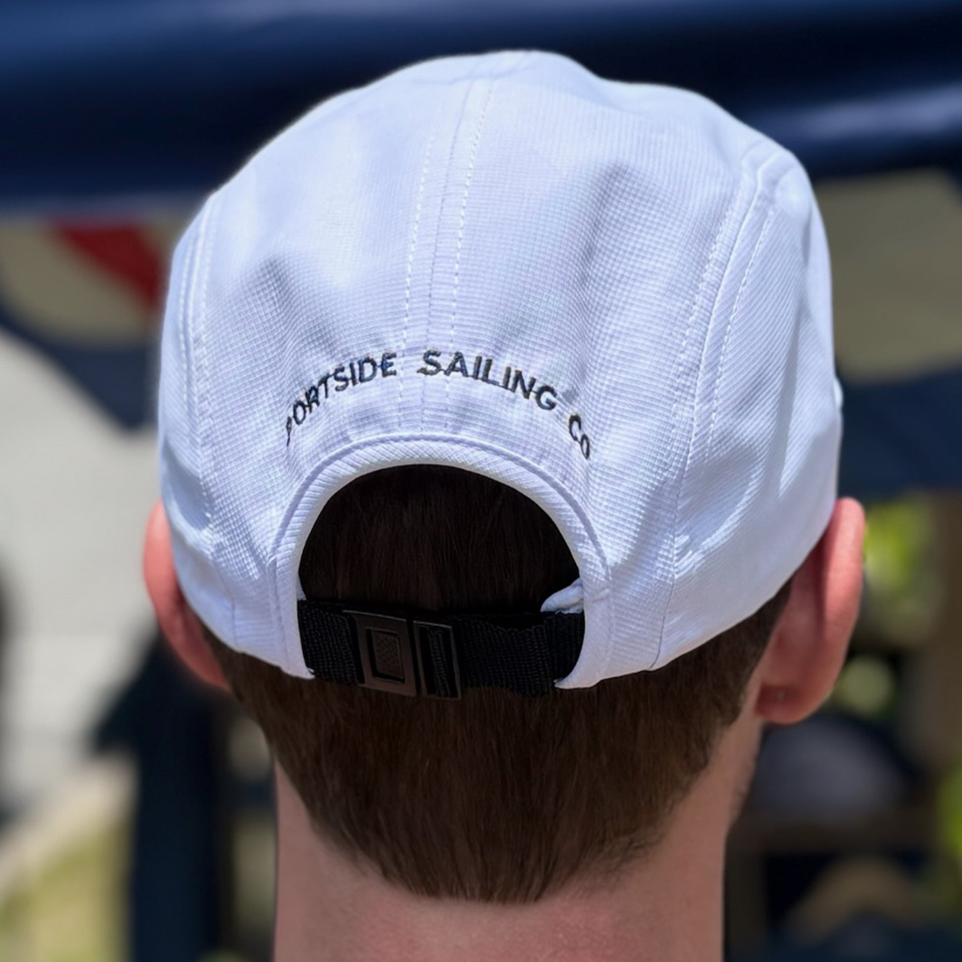 Lightweight white dry-fit hat designed for coastal wear, with embroidered Portside Sailing Co on the back.