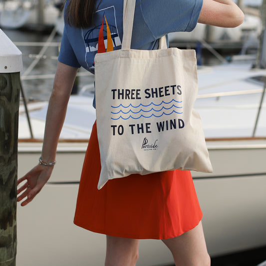 Nautical-themed tote bag featuring the humorous sailor phrase 'Three Sheets to the Wind,' perfect for a lighthearted maritime accessory.