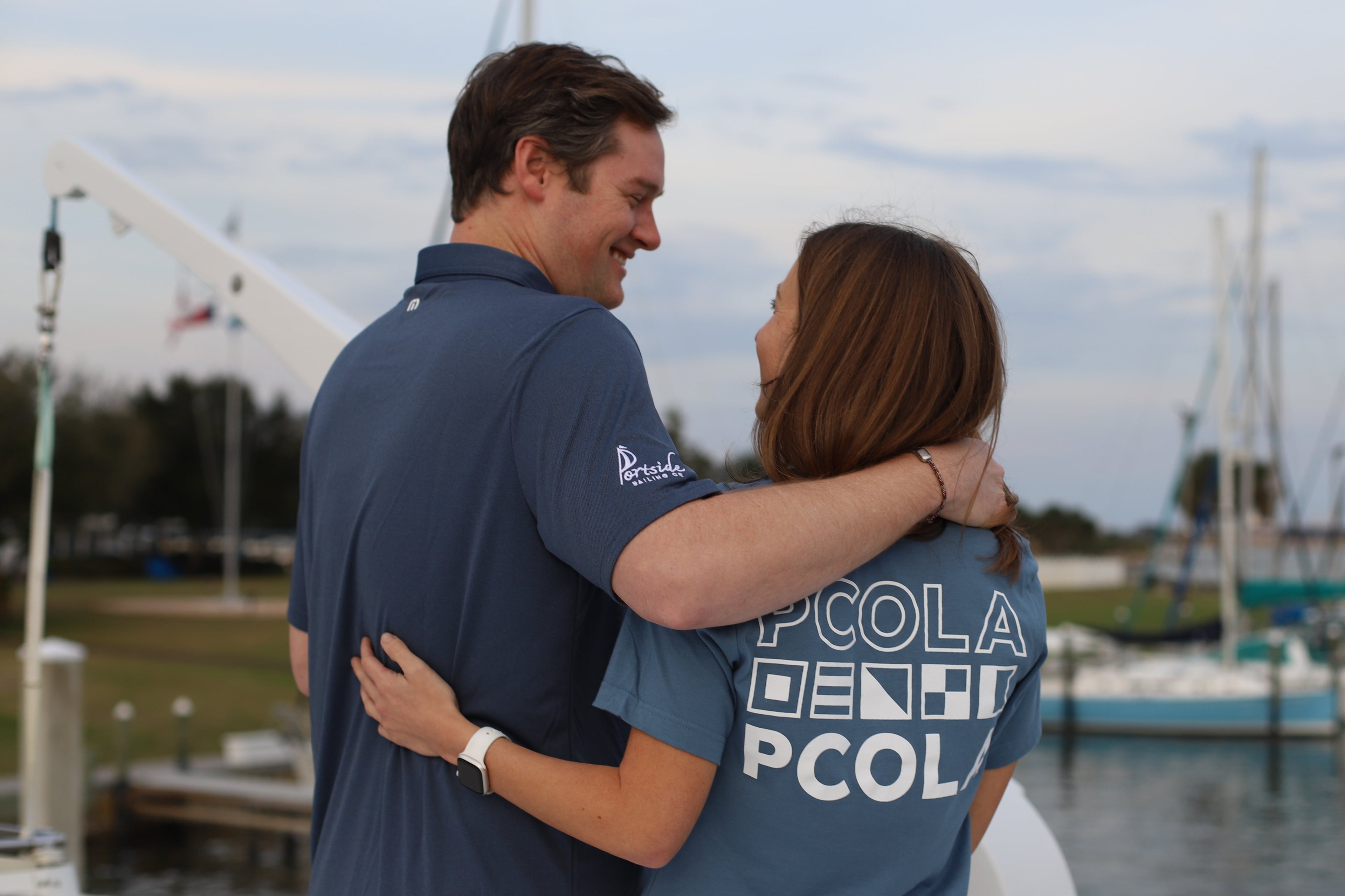 A pair of fashion-forward individuals sporting Pensacola-based Portside shirts, perfect for couples who love coastal living and quality apparel.