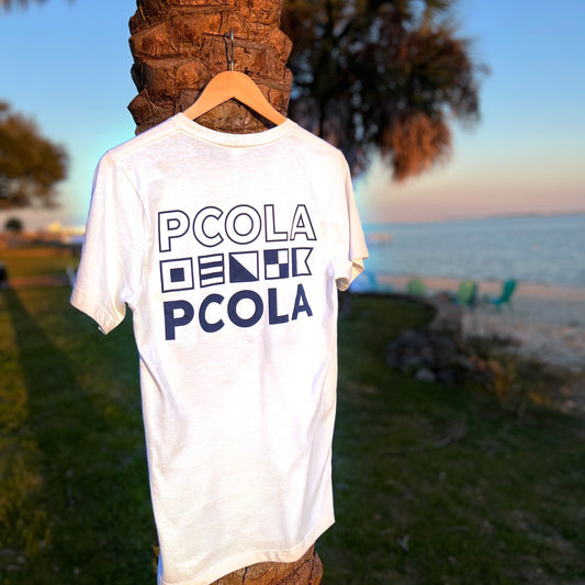 White Portside Sailing Co. t-shirt featuring signal flags spelling 'Pensacola,' a nautical-inspired design for sailors and beach lovers.
