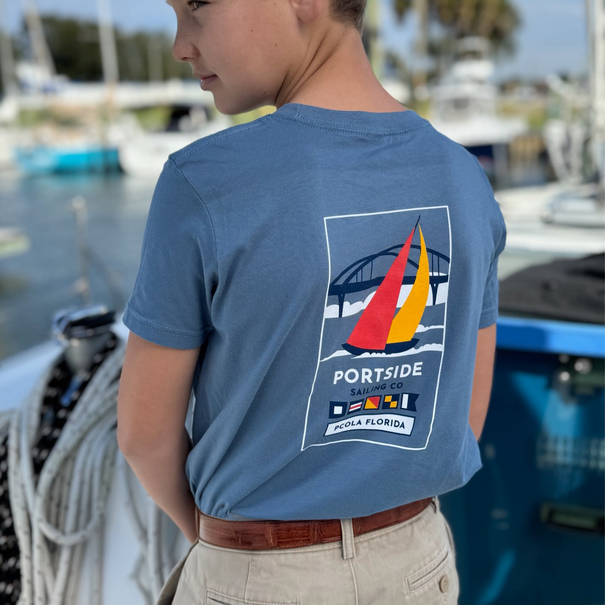 Kids' t-shirt featuring a vibrant graphic of the Pensacola Bay Bridge, a perfect way for young adventurers to show off their love for Pensacola.